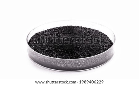 graphite powder used in industry, black powder with isolated white background and copy space. Royalty-Free Stock Photo #1989406229
