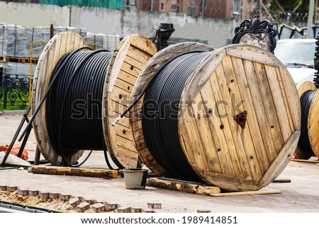 Large wire spools on the construction site. Installation of urban electrical networks. Close-up
