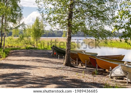 Boats on the shore of the lake. Fishing. Summer landscape. Summer background. Camping. Rest in your own country. High quality photo