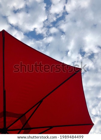 Red patio umbrella, summer sky