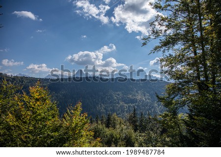 Beautiful panoramic view of a mountain landscape at summer under the sunlight and the cloudy blue sky, nature background