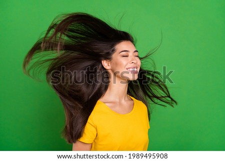 Photo portrait of dreamy girl with long brunette hair flying enjoying wind smiling isolated bright green color background copyspace