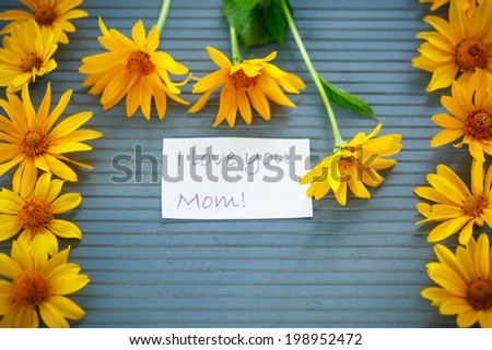 bunch of yellow daisy flowers on a wooden table