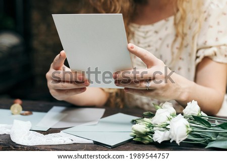 Woman preparing a wedding invitation card Royalty-Free Stock Photo #1989544757