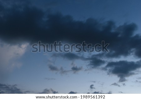 Long exposure picture of dark thunderstorm or rainy clouds and amazing blue sky.