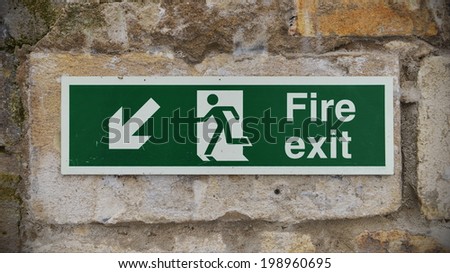 View of a Generic Fire Exit Sign on a Stone Wall