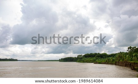 A beautiful landscape of Bangladesh. Great picture of a river. Cloudy skies in the midday sun. It is the river Gorai (Madhumati).