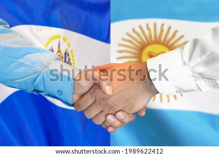 Business handshake on the background of two flags. Men handshake on the background of the El Salvador and Argentina flag. Support concept