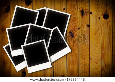 Photo frames on wooden board background texture