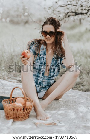 beautiful lady on a blanket near blooming trees