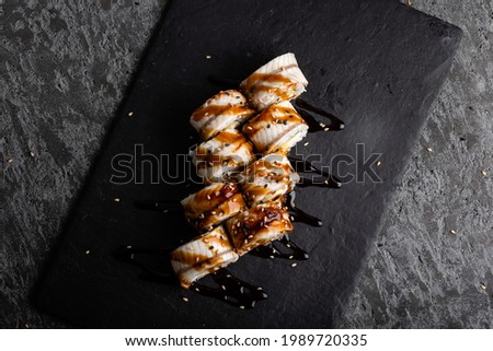 Set of fresh tasty philadelphia sushi rolls with soy on a dark background. Top view.