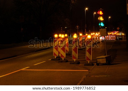 Traffic light at a construction site in night
