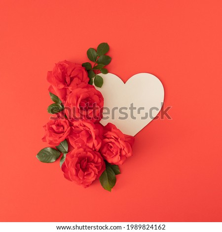 fresh red roses with frame on the apple red background. elegance summer blooming background. minimal flat lay with copy space