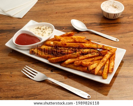 french fries delicious snacks, classic salted french fries and masala french fries Royalty-Free Stock Photo #1989826118