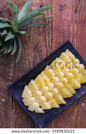 Top view Pineapple slices and pineapple shelled Asian-style on the wooden background in asia.