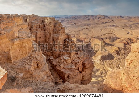 Ramon Crater is an erosional crater in the Negev Desert. It is one of five craters in the Negev. At the edge of the crater is the city of Mitspe Ramon.  Royalty-Free Stock Photo #1989874481