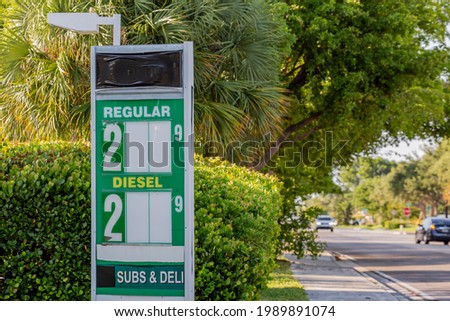 Gas station fuel price sign with the numbers missing and tape covering the logo 