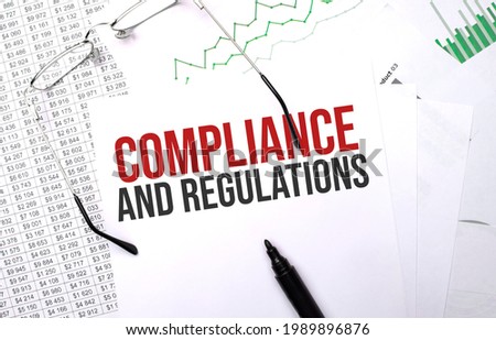 Compliance and Regulations . Conceptual background with chart ,papers, pen and glasses