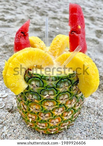 Coco Loco in Costa Rica - a fresh pineapple filled with coconut water and other fruit juices Royalty-Free Stock Photo #1989926606