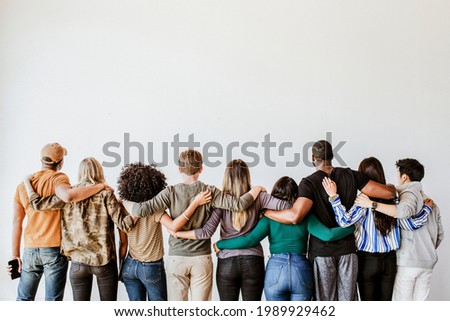 Rearview of diverse people hugging each other Royalty-Free Stock Photo #1989929462