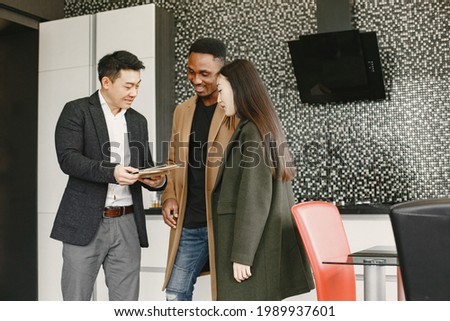 Couple discussing with designer or rieltor apartment project