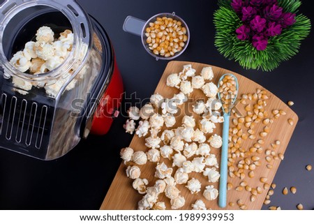 flat lay photo of popcorn maker and popcorn.