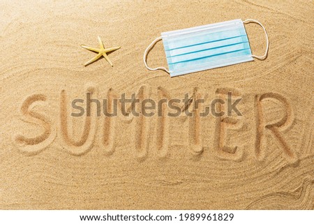 Text on the sand, starfish and medical mask, concept on the theme of wearing masks on the beach.