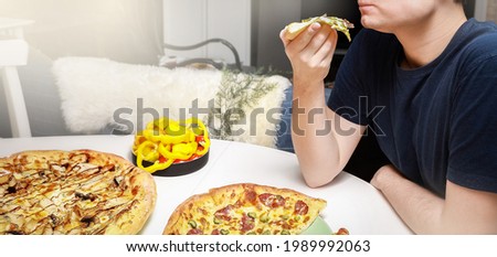 A man holds in  hand a piece of pizza  on a white table, served with different pizzas and sliced sweet yellow peppers and cherry tomatoes, flat lay, copyspace, close-up, banner