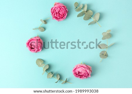tender flatlay composition with flower on blue background. Concept creative summer flatlay, top view, cover for notebook, catalog, postcard, top view, copyspace, frame.