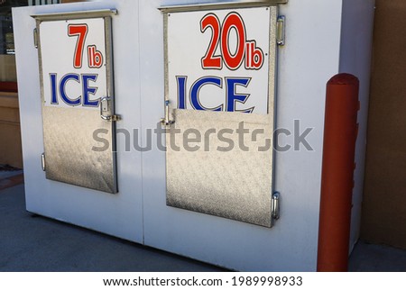 Ice chest with ice for sale outside a convenience market.