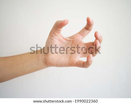 Asian hand muscle spasm . Disorder of one hand. abnormally bent fingers on a white background. Royalty-Free Stock Photo #1990022360