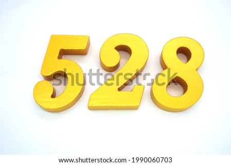   Arabic numerals 528 gold on white background                             