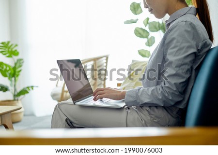 Young woman using a computer in the living room