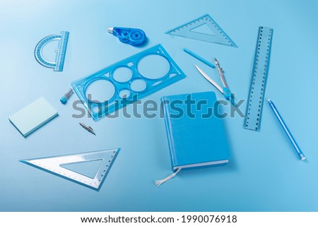 School supplies. Painting and sketching supplies. Blue items on a blue background.