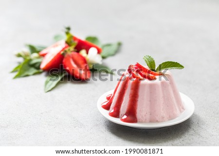 Dessert, creamy strawberry pudding with sauce on a plate on a light background Royalty-Free Stock Photo #1990081871