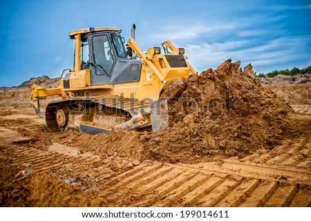 Excavator working with earth and sand in sandpit in highway construction site Royalty-Free Stock Photo #199014611