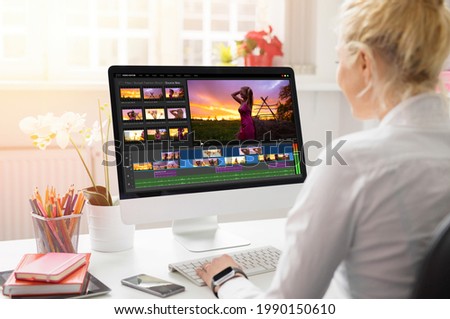 Woman editing video on desktop computer