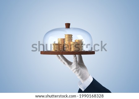 Financial services concept. Financial advisor or employee of the bank providing a loan represented by coins of money. Royalty-Free Stock Photo #1990168328