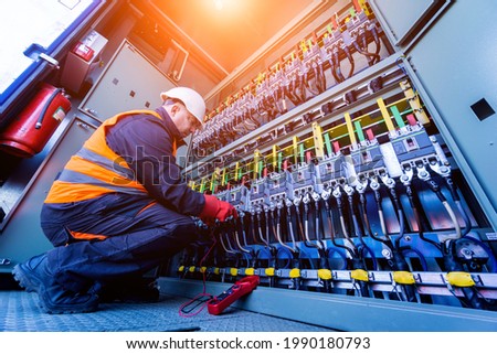 Checking the operating voltage levels of the solar panel switchgear compartment Royalty-Free Stock Photo #1990180793