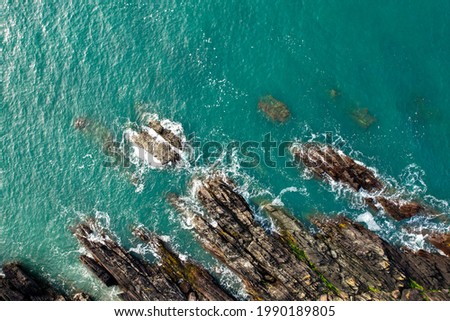 Details of turquoise water near a rocky coastline in the sea