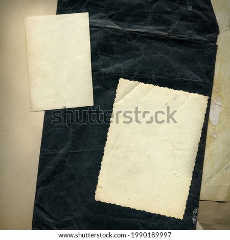 Old vintage photographs. Retro photo texture. Grunge background with old notebook and photos. Pile of old photos template cutout. Aged and yellowed postcard.