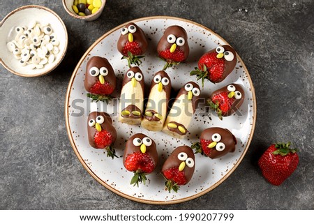 Strawberries and bananas in chocolate in the form of birds. Cute idea for kids party. 