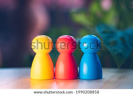 Closeup colorful wooden people on blurry background using as business relationship and education creativity concept