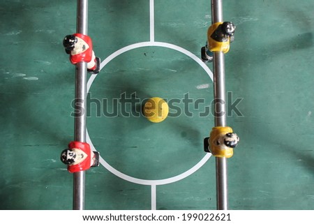 Foosball football soccer table top in team colours red and yellow stock, photo, photograph, picture, image