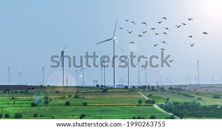 Wind turbines farm.Clean energy. Wind energy. Field with many wind turbines.  Royalty-Free Stock Photo #1990263755