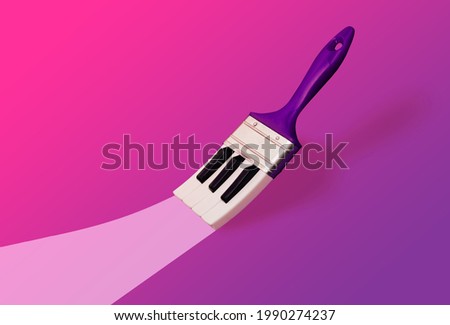 Paintbrush with piano keys which painted a bright trace on vibrant, bold pink-purple gradient background with copy space. Aesthetic, abstract, surrealistic minimal music idea. Creative paint concept. Royalty-Free Stock Photo #1990274237