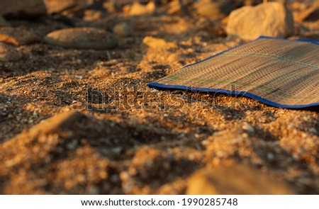 Beach mat in the Kamenka beach at sunset. Russia, Sea of Azov, Krasnodar Territory, Yeysk.