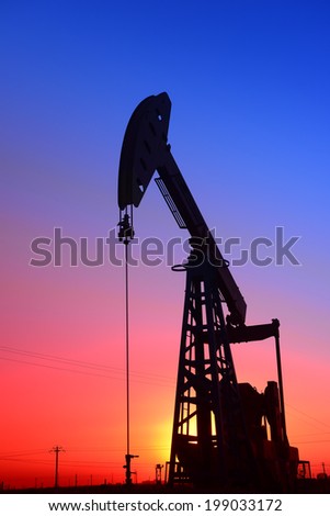 Sunset is a job of the pumping unit in oil field  