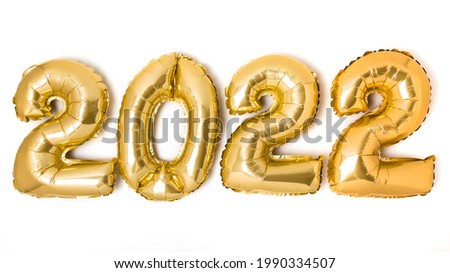 Golden 2022 balloons. Gold metallic foil numbers for Happy New Year celebration on white background. Helium balloon as holiday party decoration or postcard concept.