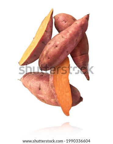 Fresh raw sweet potato falling in the air isolated on white background. Food levitation concept. High resolution image